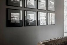 a moody symmetrical black and white gallery wall with matching black frames and black and white pics for a moody space