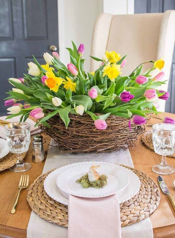 a nest with colorful tulips and daffodils is a bright and fun spring centerpiece that is cool for Easter too