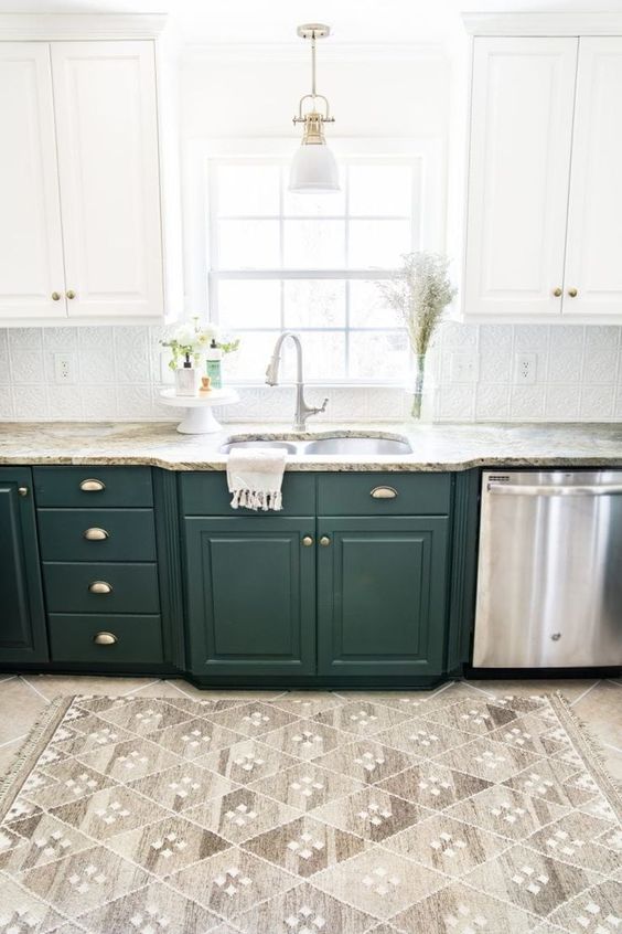 a one wall two tone kitchen in white and dark green, with stone countertops and a patterned tile backsplash