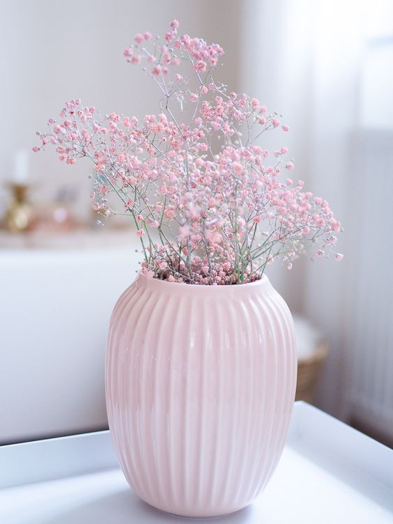 a pastel pink vase with pink baby's breath is a very beautiful spring decoration and centerpiece in one