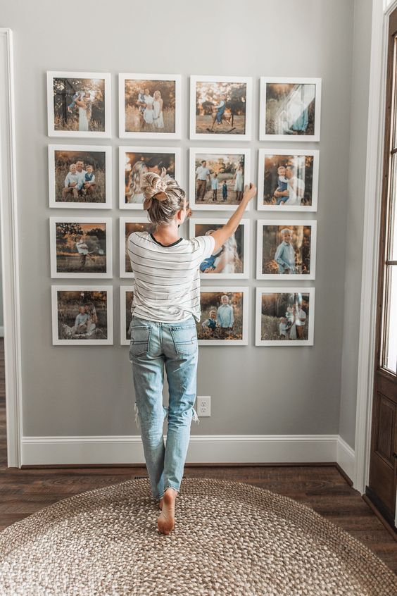 a pretty Polaroid-inspried grid gallery wall with thick white frames, no matting and colorful family photos is a fresh take on traditional gallery walls