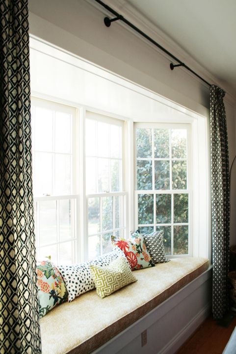 a pretty bow window with a windowsill daybed and colorful pillows is a lovely idea for a modern space