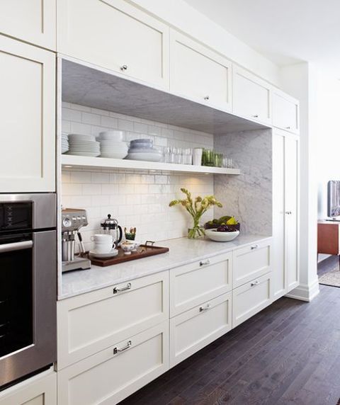 a pretty farmhouse one wall kitchen in white, with a white stone and subway tile backsplash is a cool idea