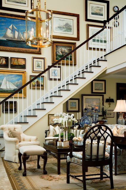 a refined and chic vintage gallery wall with mismatching frames and paintings and prints is a lovely idea for a staircase