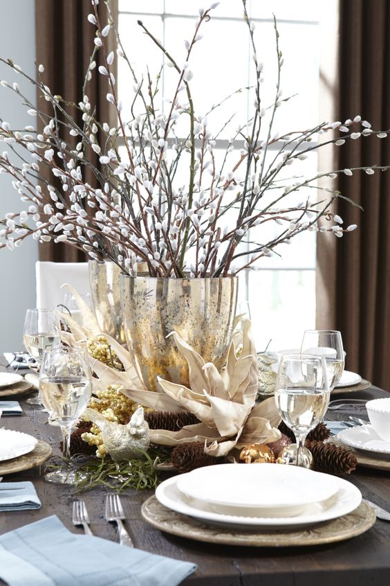 a refined spring centerpiece of a gold vase and willow is a traditional and cool idea for spring