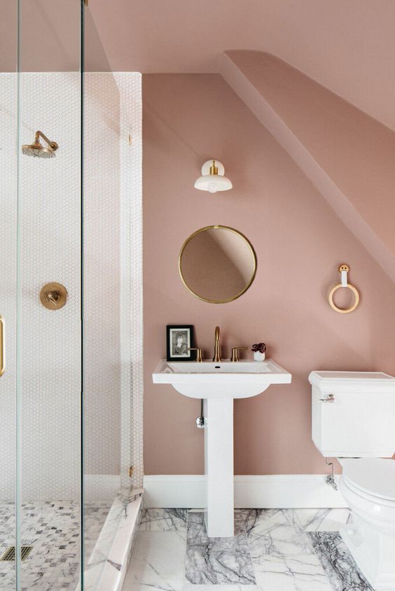 a romantic mauve bathroom with a shower space, white appliances, round decor