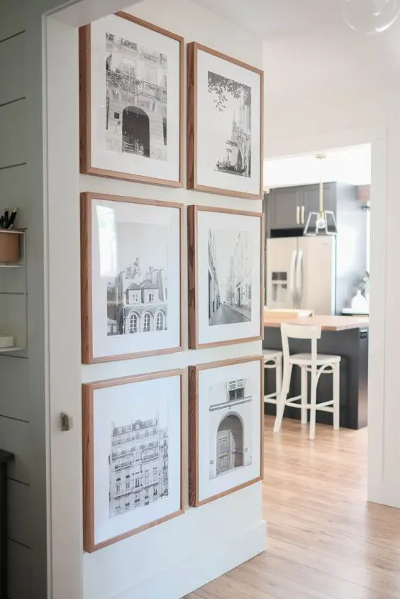 a small and chic gallery wall with blonde wood frames, white matting and beautiful place photos looks a bit farmhouse