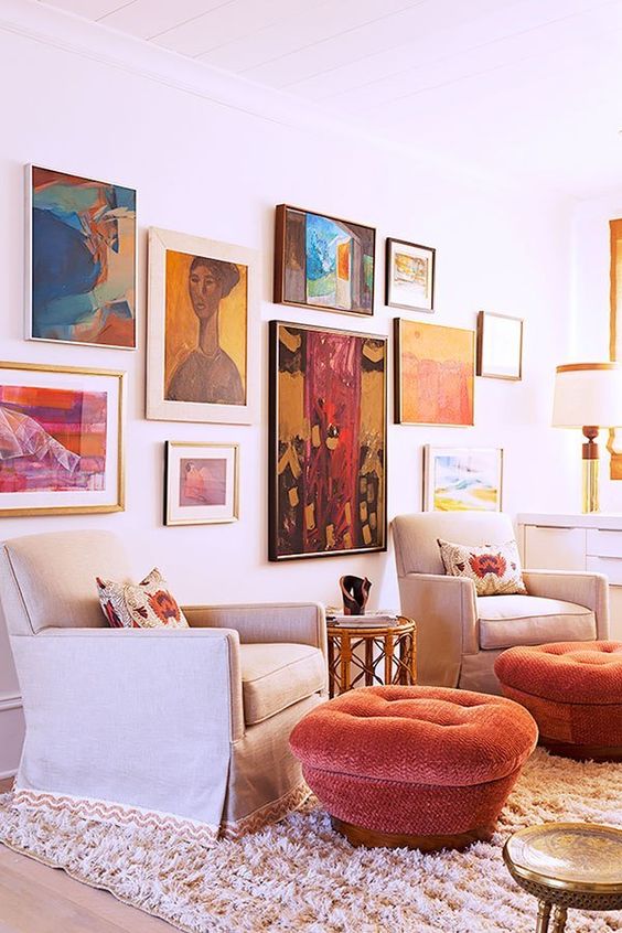 a statement and colorful gallery wall with large scale and bold artworks in mismatching frames is a lovely idea