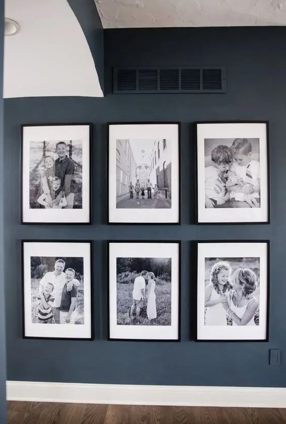 a stylish gallery wall with large black and white photos, white matting and black frames will be a nice idea for a farmhouse space