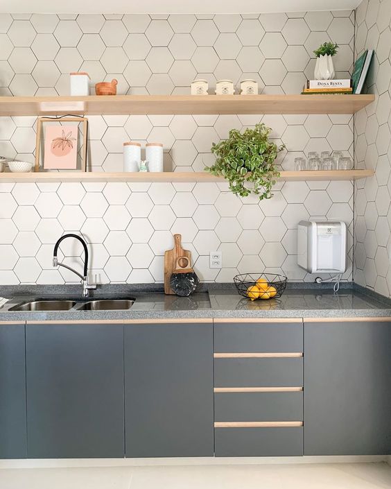 a stylish graphite grey one wall kitchen with a white hex tile backsplash and open blonde wood shelves