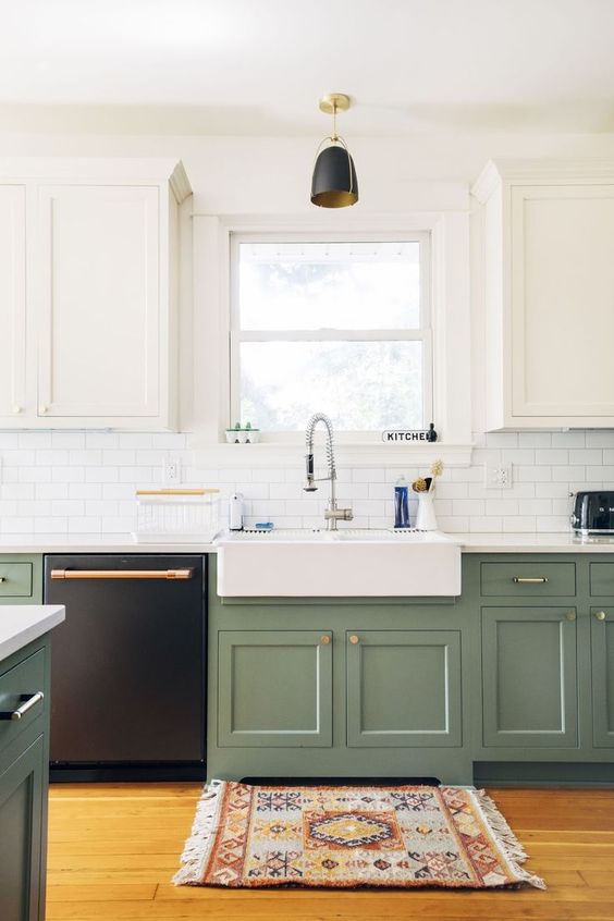 a two tone one wall kitchen with farmhouse cabinetry, a white subway tile backsplash, a white countertop and a black pendant lamp