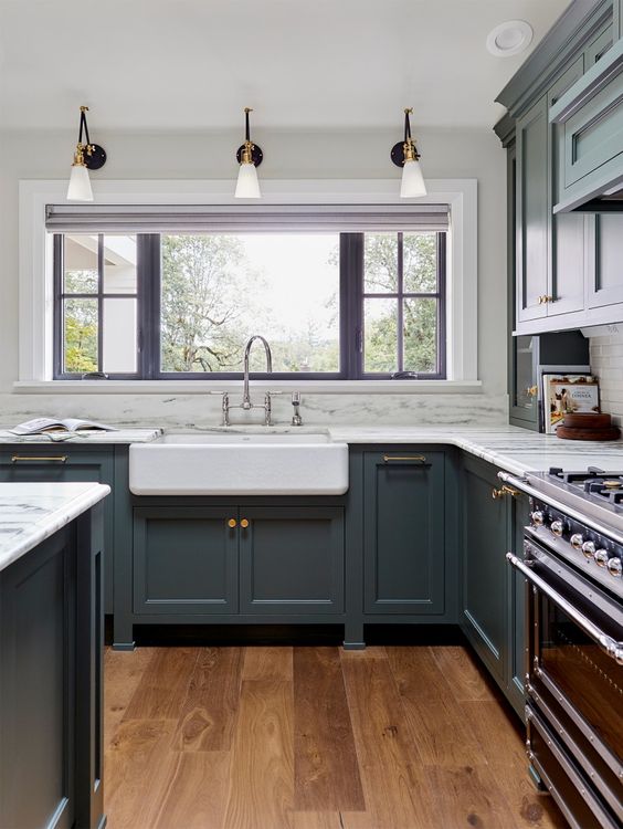 a vintage grey kitchen with shaker style cabinets, white quartz countertops, vintage fixtures and sconces plus mixed metals