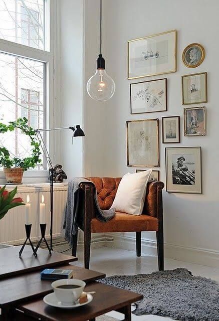 A vintage inspired gallery wall with gold and dark frames, with vintage art and prints is very chic