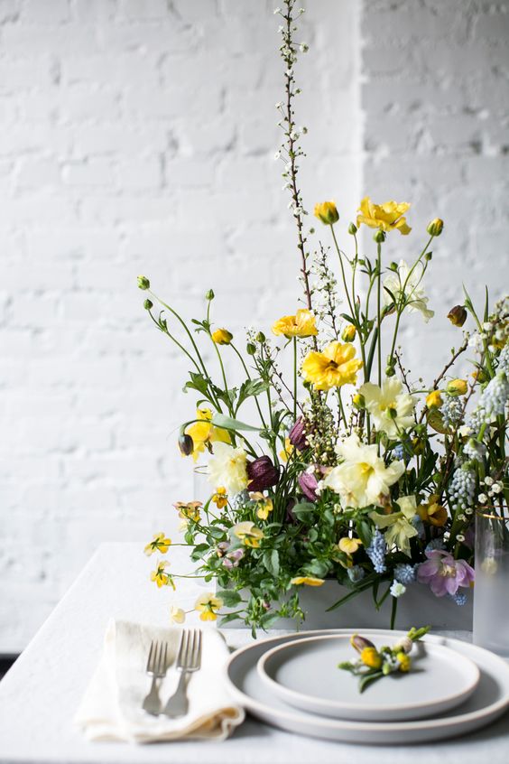 a white box with bright blooms and greenery is a very fresh and bright contemporary arrangement for spring