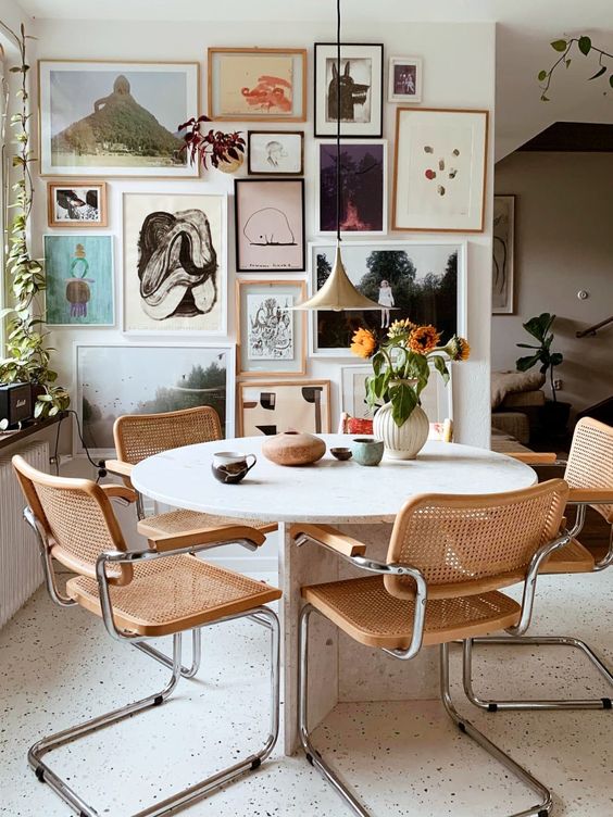 an eclectic gallery wall with various types of art in mismatching frames is amazing and looks wow