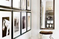 an elegant entryway with a grid gallery wall, a printed rug, a mirror and a chic and cool stool