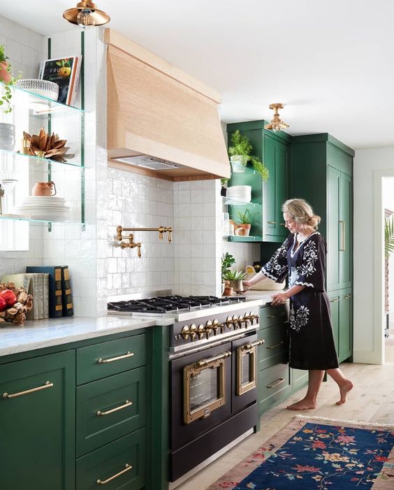 an emerald shaker style kitchen with white countertops, a wooden hood and a white square tile backsplash is amazing