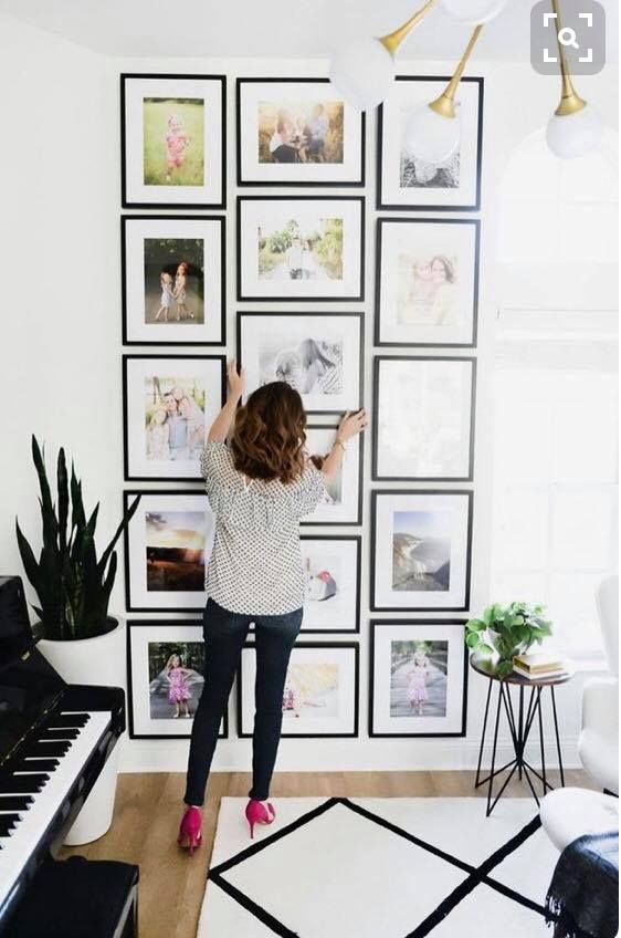 an eye-catchy grid gallery wall with thin black frames that mismatching in sizes but still form a rectangle