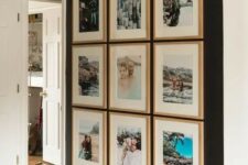 an inspiring symmetrical gallery wall with colorful photos from vacations in matching wood frames will raise your best memories