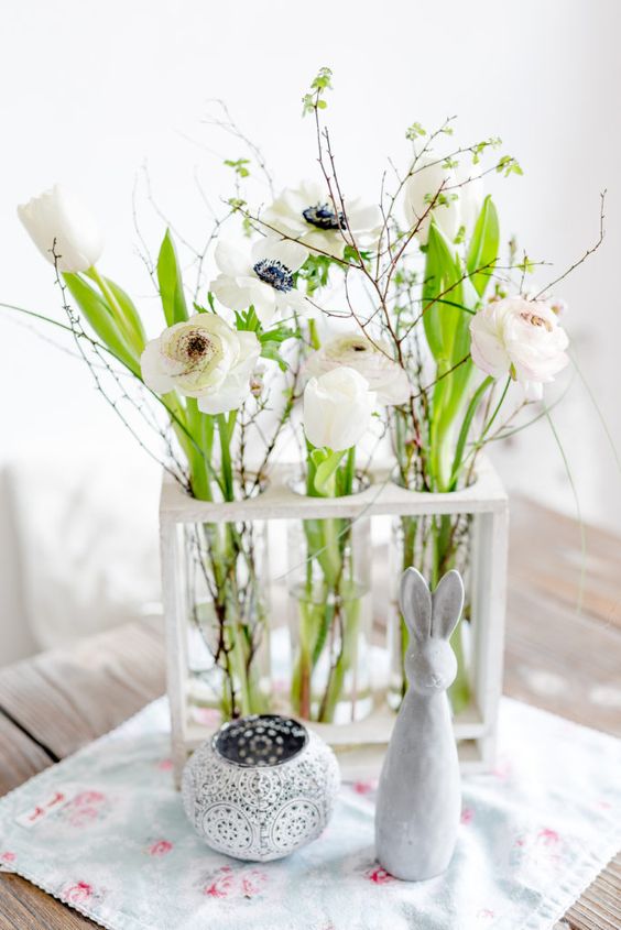 tube vases in a frame, with white blooms, greenery branches and twigs is a simple and cute centerpiece for spring