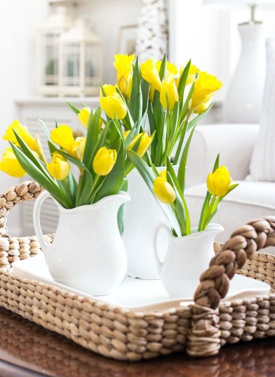 white milk jugs with yellow tulips is a lovely and easy cluster centerpiece for a rustic spring tablescape
