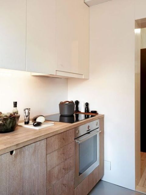 02 a contemporary kitchen with light stained lower cabinets and sleek white upper ones plus a hood is a stylish and chic space