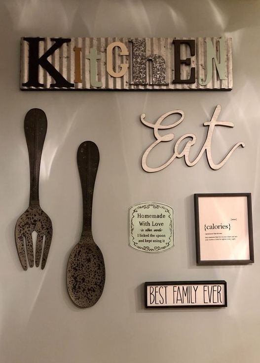 kitchen wall decor with a metal sign, an EAT sign, some large cutlery pieces and vintage mini signs on the wall