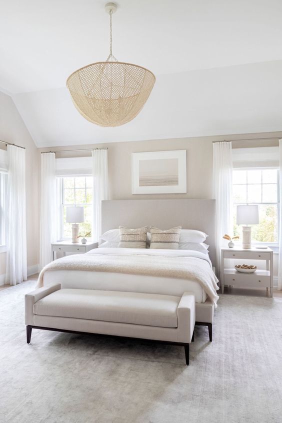 a serene modern neutral bedroom with elegant modern furniture, a catchy pendant lamp and a cool artwork is welcoming