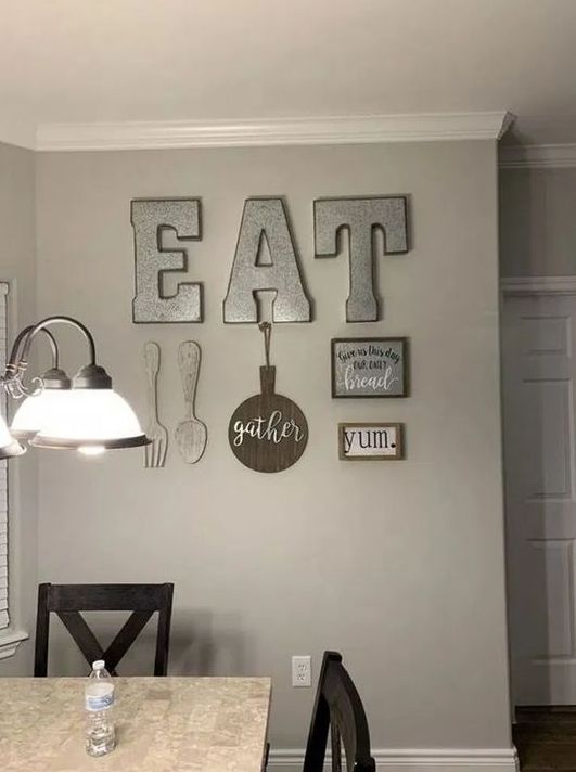 rustic kitchen wall decor with metal letters, wooden cutlery, a GATHER sign, a metal and a framed sign is lovely