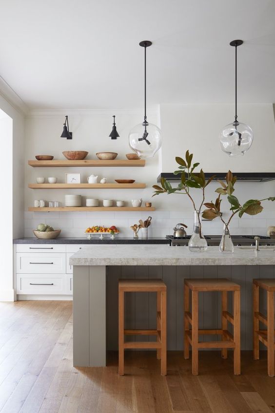 13 a modern farmhouse kitchen with white shaker cabinets and a matching white hood that is seamless in front of the wall, a grey kitchen island