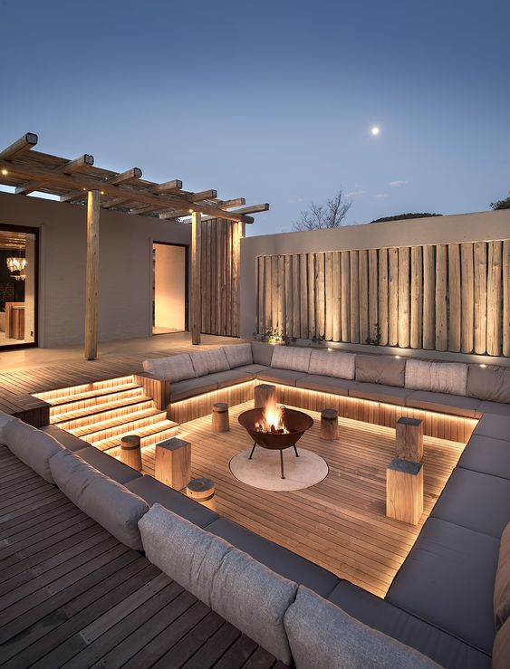 14 a refined contemporary backyard with built-in lights and a fire pit is a very welcoming and stylish idea