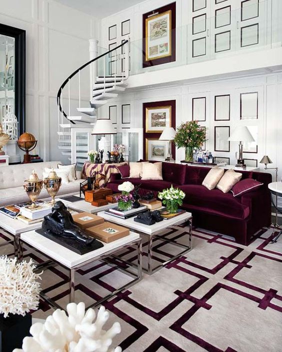 15 a beautiful living room with white paneled walls, a creamy and a purple sofa, a cluster of coffee tables and a printed white and purple rug