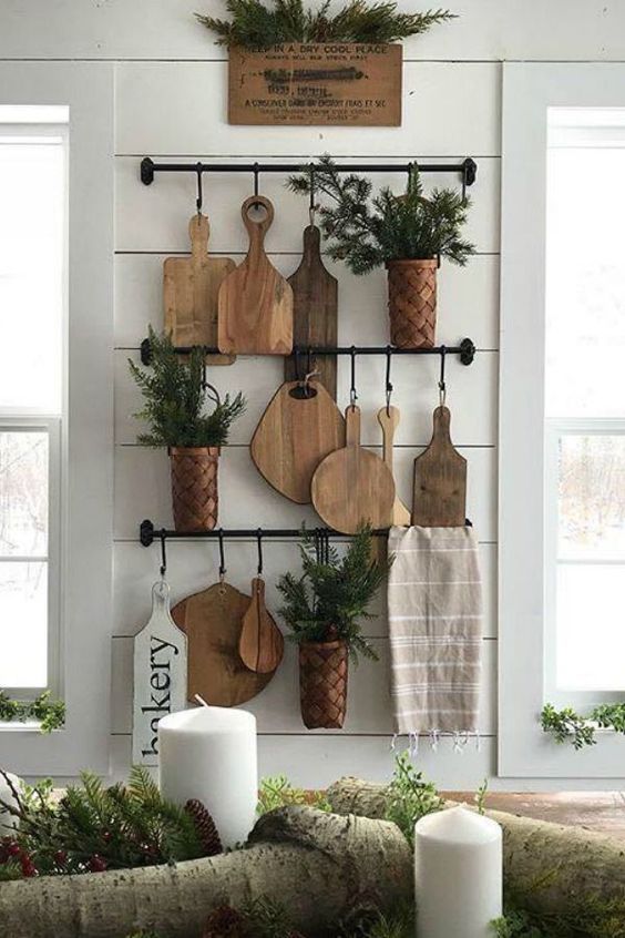 rustic kitchen wall decor with railings, cutting boards, potted greenery and a towel is a chic and natural idea