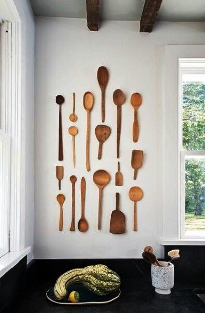 simple rustic kitchen wall decor done with wooden spoons of various sizes and looks is a lovely and cool idea to cozy up the space