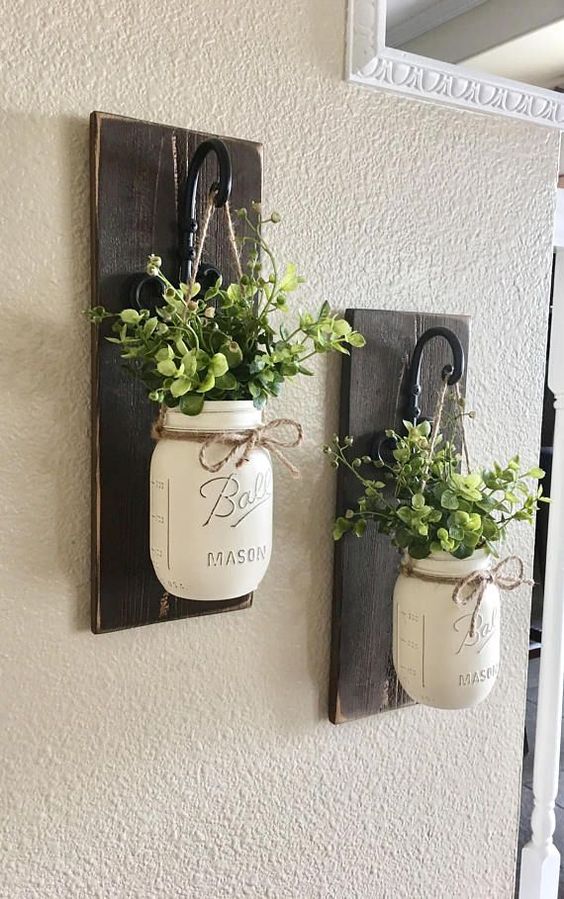 dark stained wooden plaques with hooks and whitewashed mason jars with greenery for lovely farmhouse wall decor