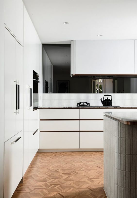 23 a white contemporary kitchen with sleek cabinets and a curved hood over the cooker is a stylsih idea