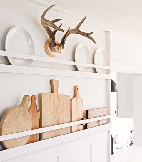 lovely neutral farmhouse wall decor with cutting boards and white plates is a great idea for a kitchen or dining space