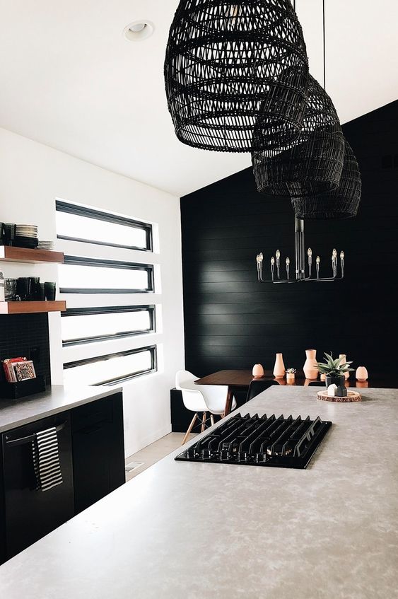 30 a bold kitchen with a black accent wall, black cabinetry and window frames plus black rattan pendant lamps