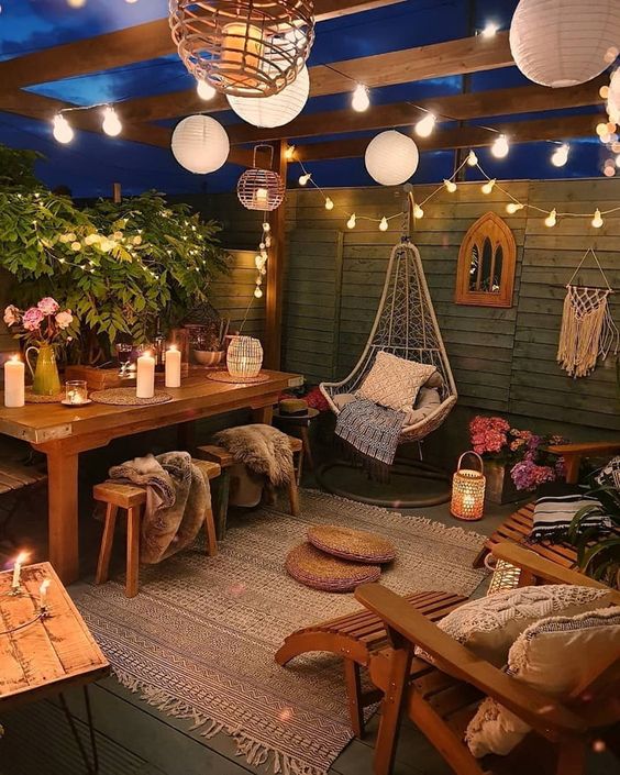 36 a relaxed and welcoming boho backyard with paper and string lights, with candles and candle lanterns