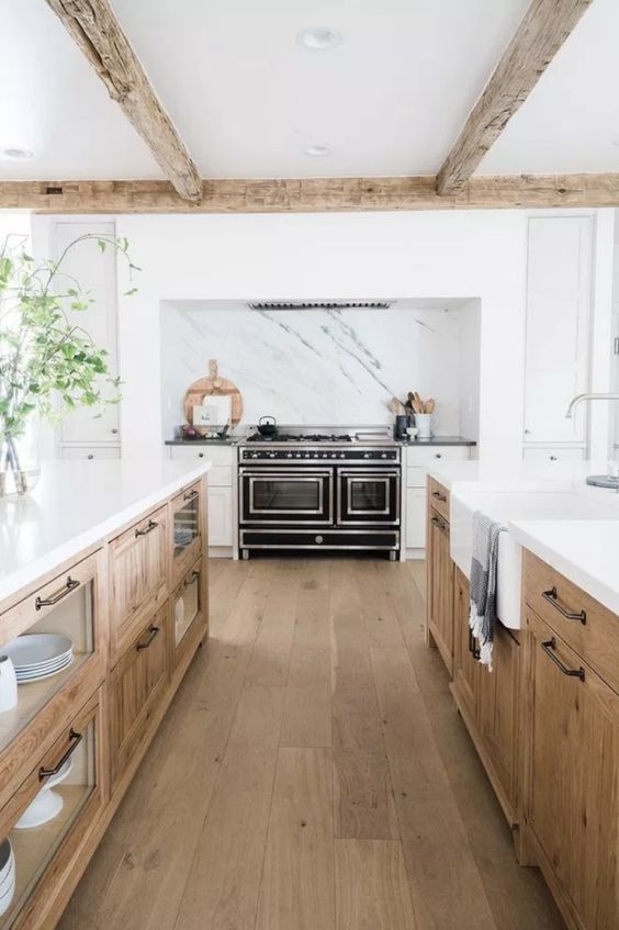 36 an elegant modern farmhouse kitchen with light stained cabinets, white stone countertops and an integrated hood over the cooker