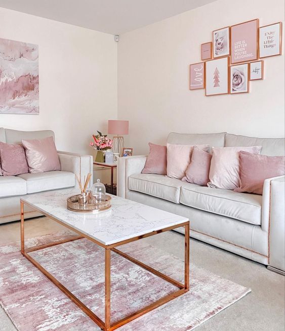 40 a simple and modern living room with grey sofas, pink and blush pillows and a rug, a pink gallery wall