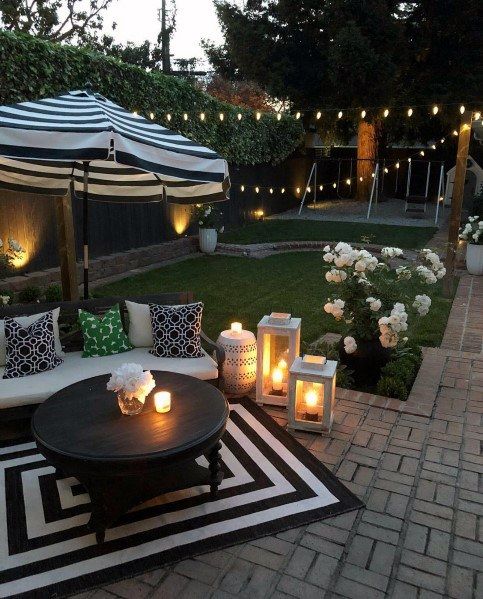 String lights, candle lanterns and built in lights make this backyard welcoming and lit up enough