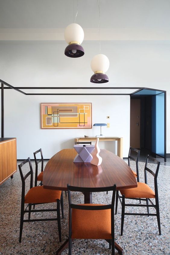 a beautiful mid-century modern dining room with a grey terrazzo tile floor, chic dining furniture and pendant lamps