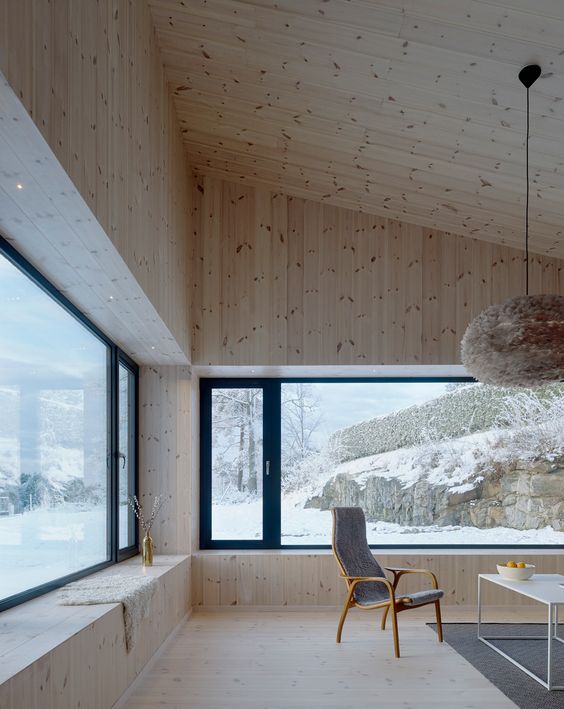 a chalet space with blonde wood cladding the walls, floors and ceilings looks amazing, welcoming and very cozy