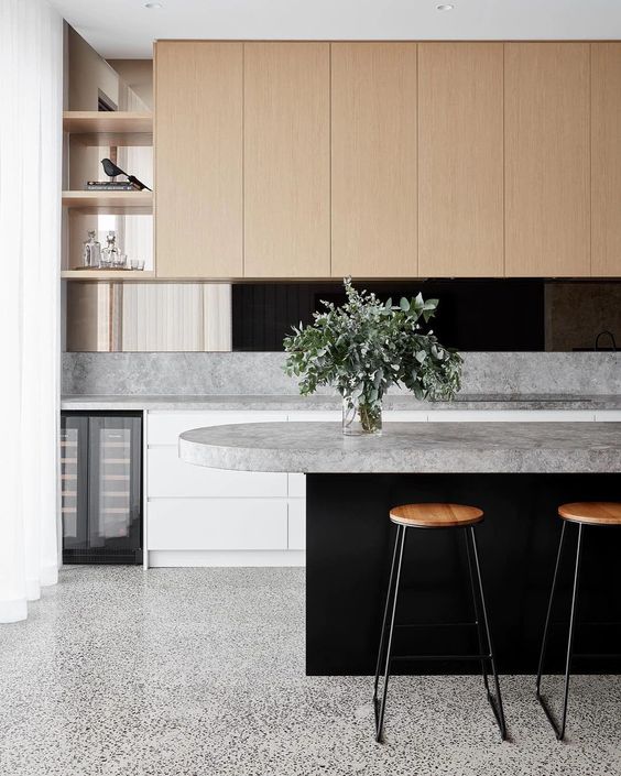 a minimalist kitchen with a grey terrazzo floor, sleek cabinetry and grey stone countertops that add interest just like the floors
