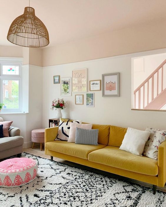 a vivacious living room with a yellow sofa, a lovely gallery wall, printed textiles and a rattan pendant lamp