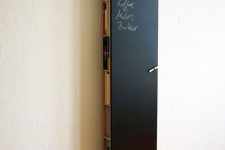 06 a tall and thin chalkboard storage unit hiding books, magazines and a wi-fi router can double as a note board or an art one