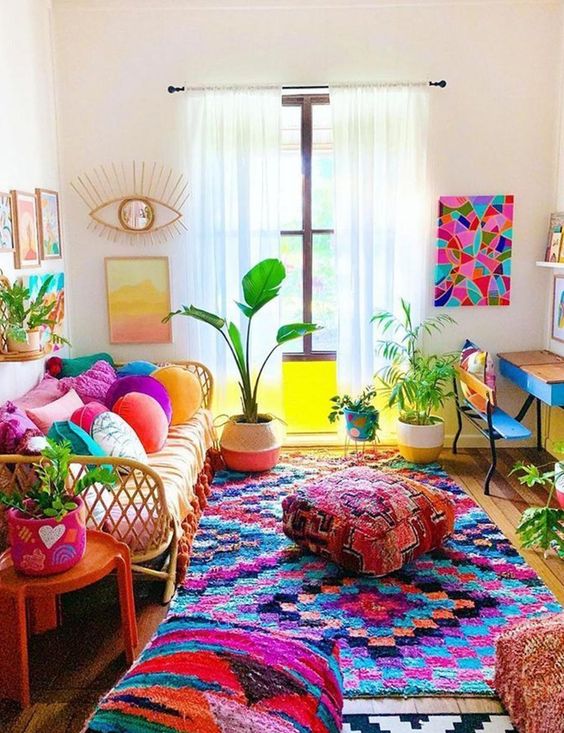 a bold maximalist living room with rattan and wooden furniture, colorful pillows, textiles and ottomans, potted plants