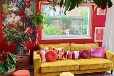a bold maximalist living room with red walls, a yellow sofa and colorful stools, bold rugs, lovely artworks and potted plants