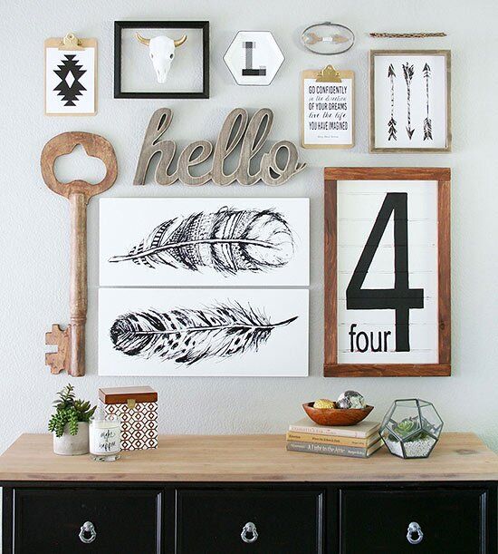 a chic mid-century modern gallery wall with a rustic feel - signs, a wooden key, some artworks and calligraphy is chic